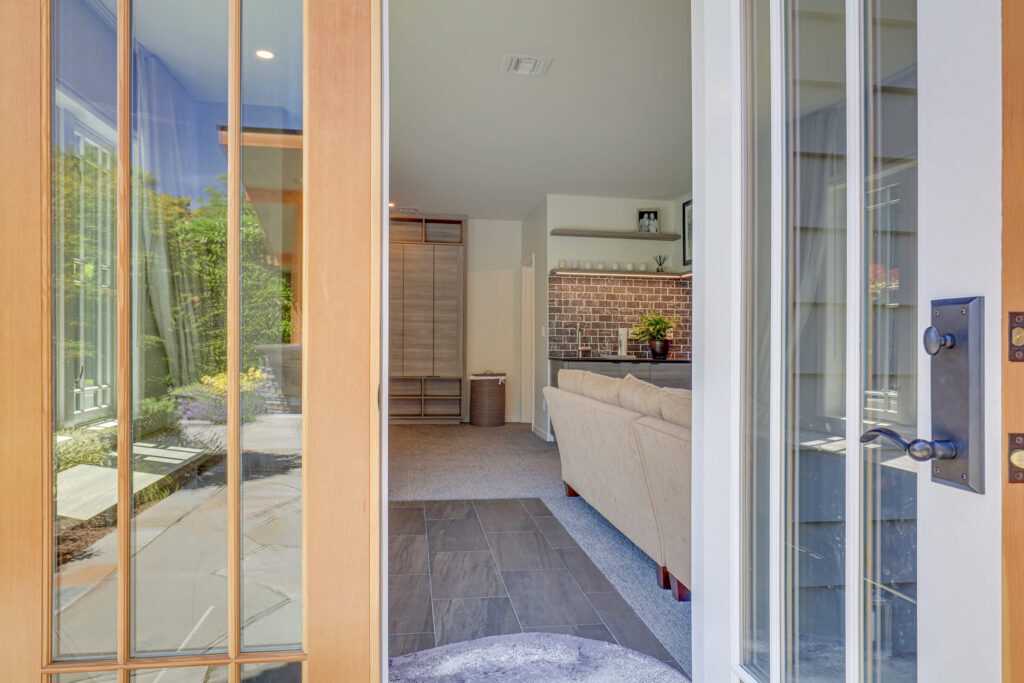Modern living room viewed through open glass door