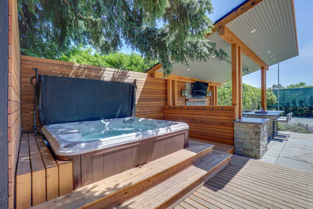 Outdoor home spa area with hot tub and kitchenette