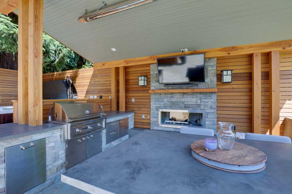 Modern outdoor kitchen with grill and fireplace