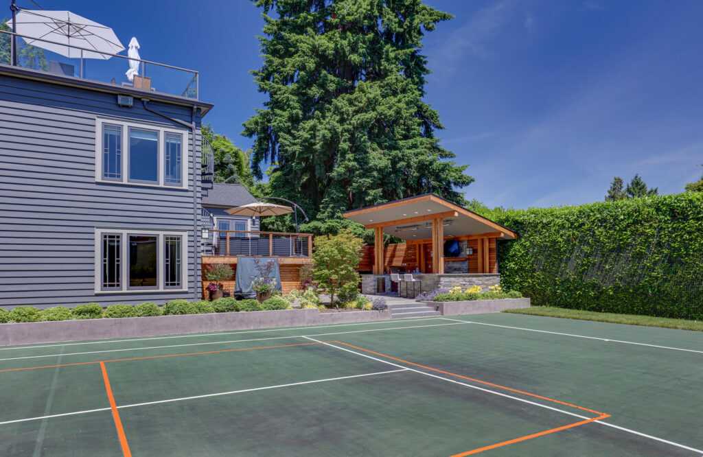 Luxury home with outdoor tennis court and patio area