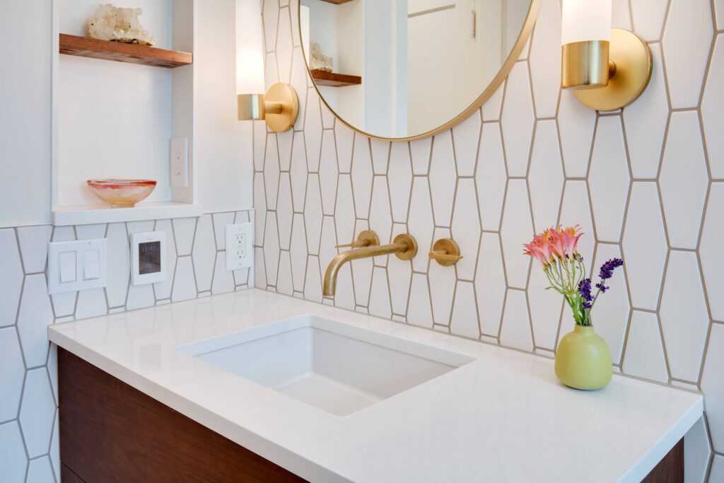 Modern bathroom with geometric tiles and gold fixtures