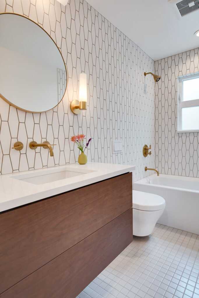 Modern bathroom with geometric tiles and golden fixtures