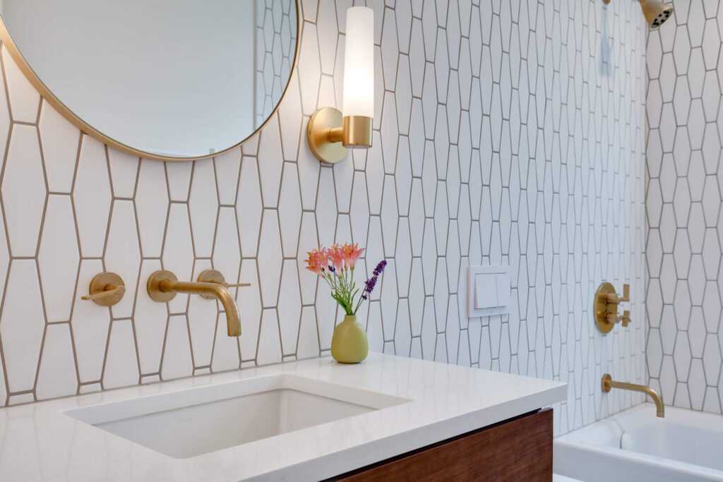 Modern bathroom with geometric tiles and gold fixtures