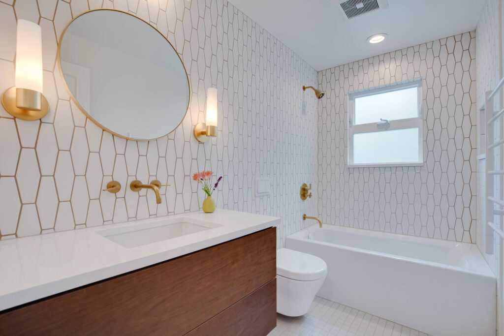 Modern bathroom with geometric tiles and gold fixtures