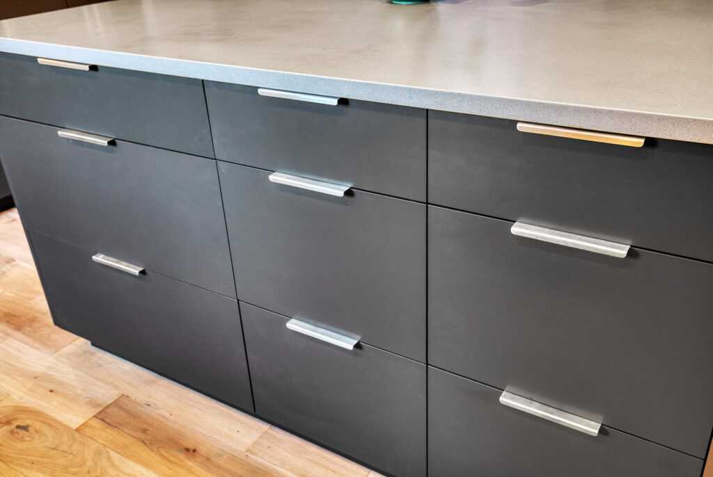 Modern gray kitchen drawers with metal handles