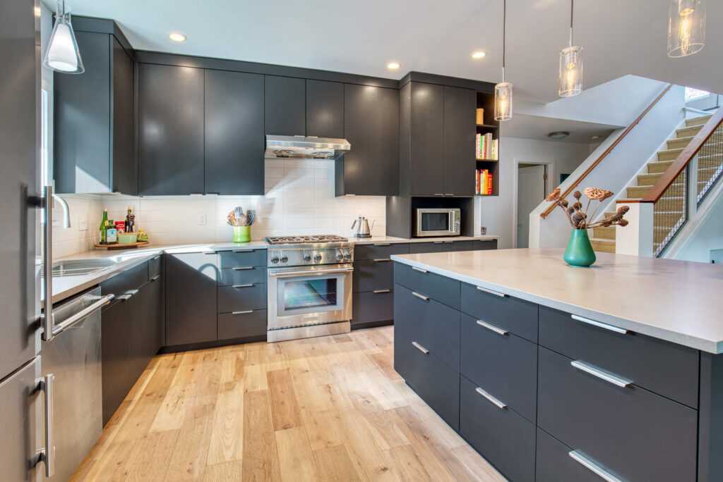 Modern kitchen with dark cabinets and wooden flooring