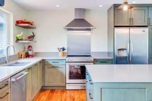 Modern kitchen with stainless appliances and wooden floor