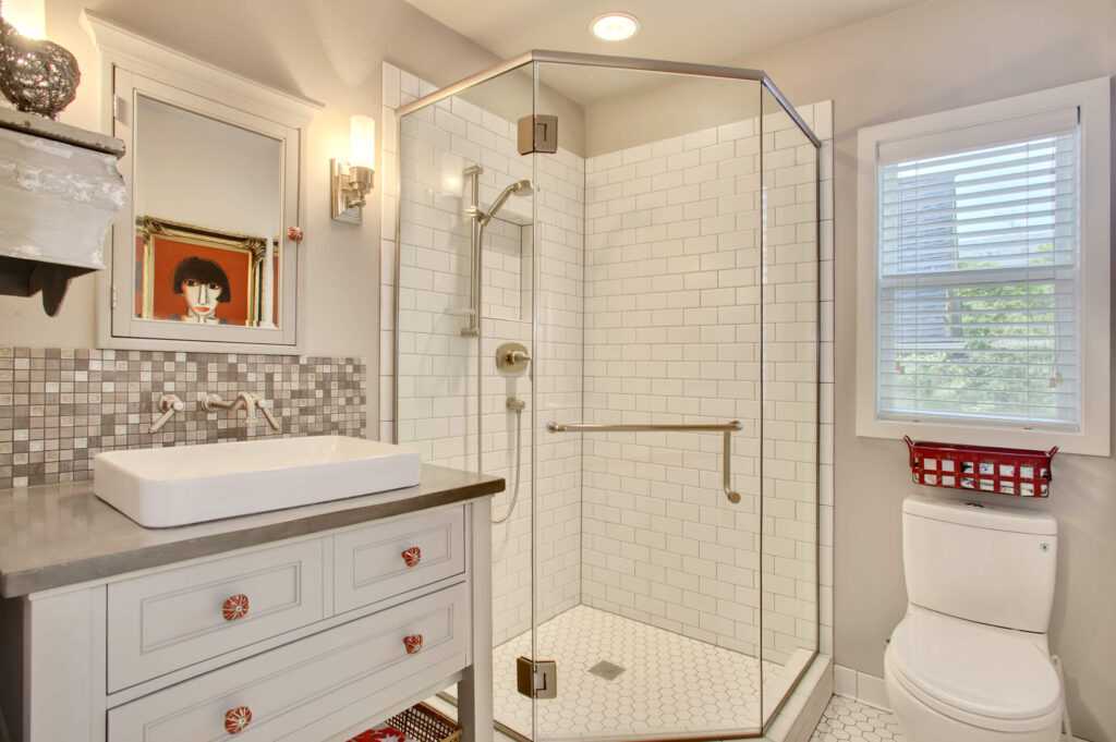 Modern bathroom with white tiles and glass shower