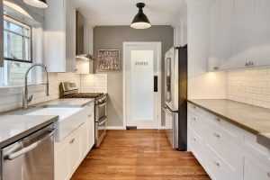 Modern kitchen with stainless appliances and hardwood floor