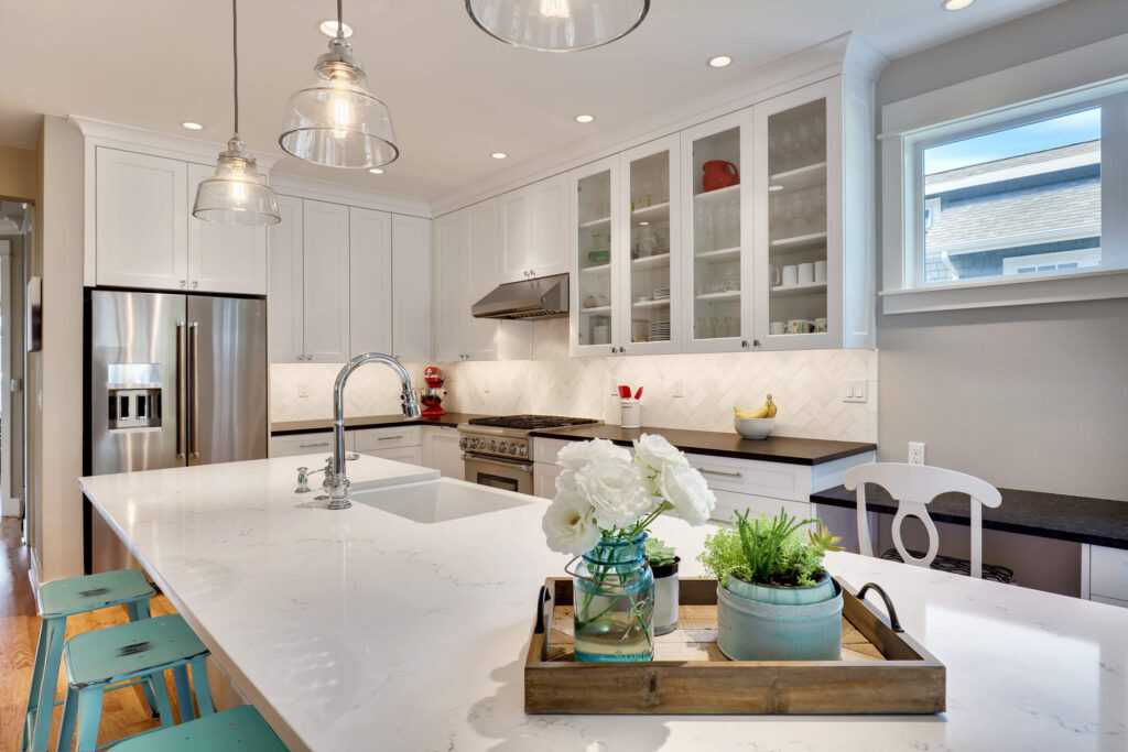 Modern kitchen with white cabinets and pendant lighting