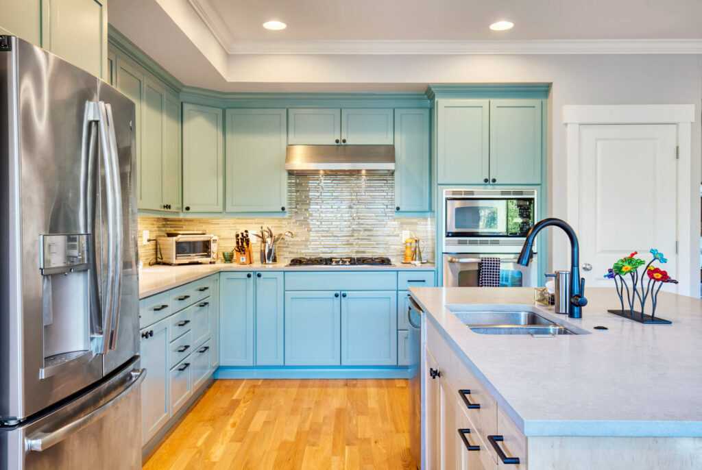 Modern kitchen with blue cabinets and stainless appliances