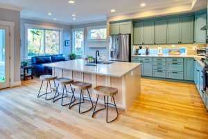 Spacious kitchen with wooden floors and blue cabinets