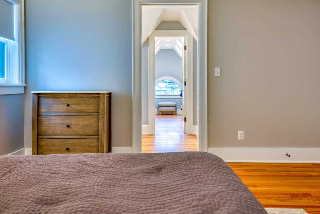 Bright hallway viewed from bedroom, wooden floors, modern decor