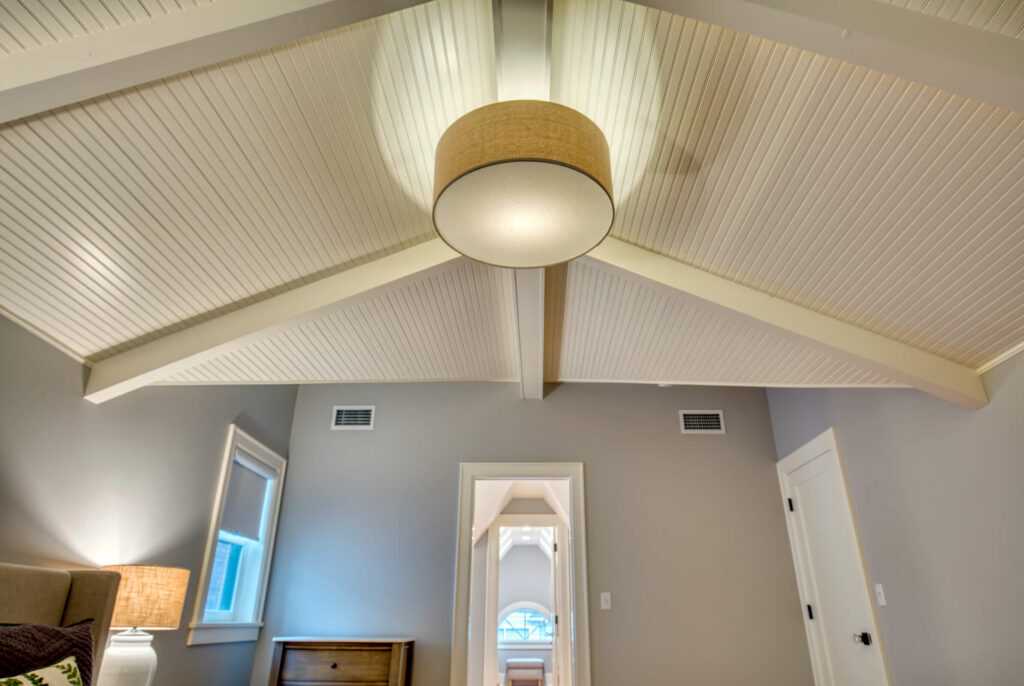 Modern room with vaulted ceiling and stylish pendant light