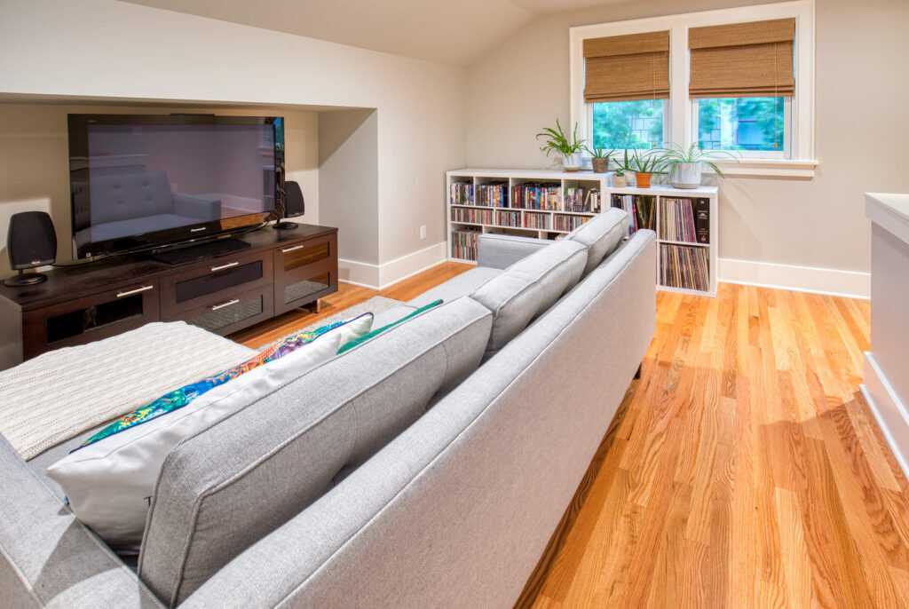 Modern living room with couch, TV, and bookshelves