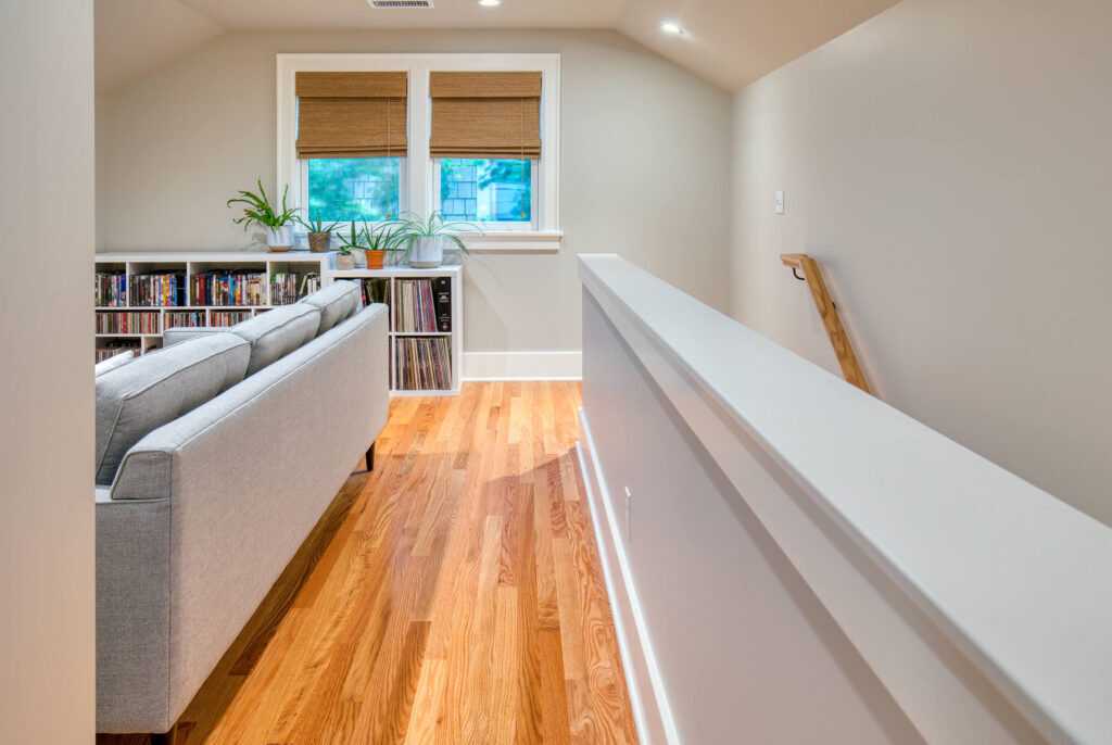 Bright hallway with wooden floors and cozy reading nook