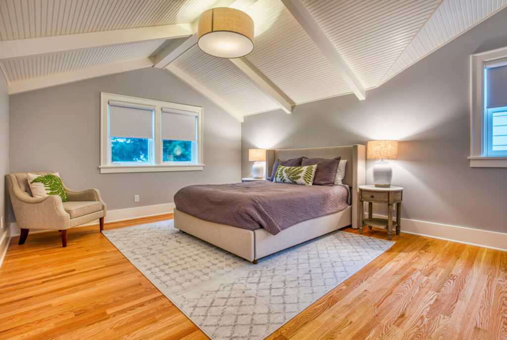 Spacious bedroom with vaulted ceilings and wooden floors