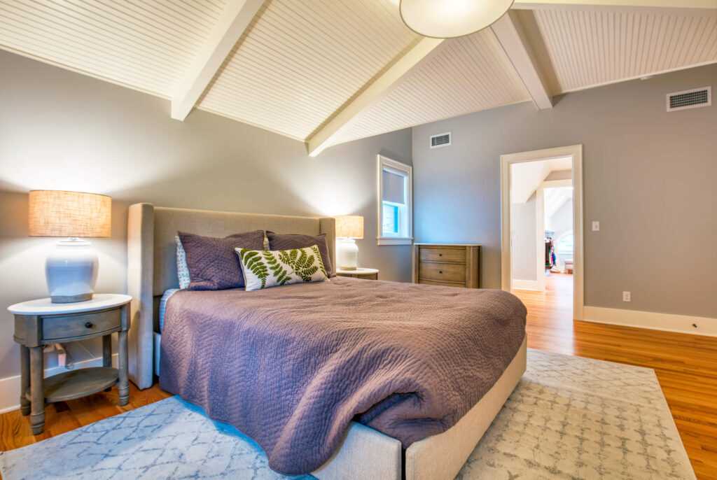 Modern bedroom with stylish decor and vaulted ceiling