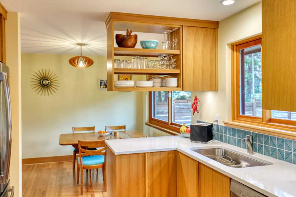 Modern kitchen interior with wooden cabinets and dining area