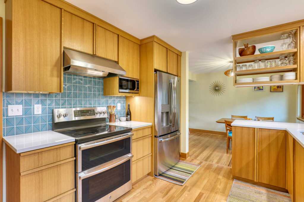 Modern kitchen with wooden cabinets and teal backsplash