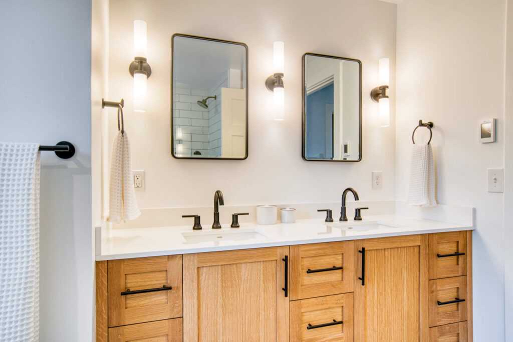 Modern bathroom with dual sinks and wooden cabinets