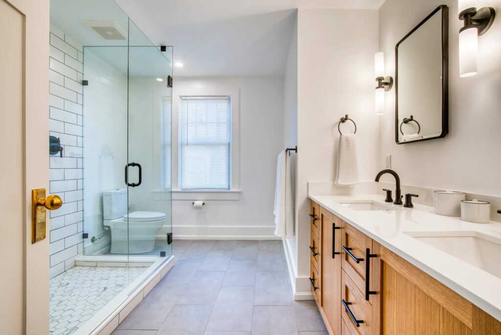 Modern bathroom with glass shower and wooden vanity