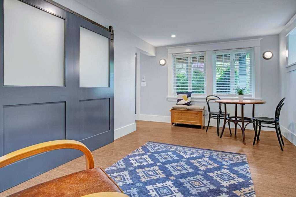 Modern dining room with sliding barn doors and rug