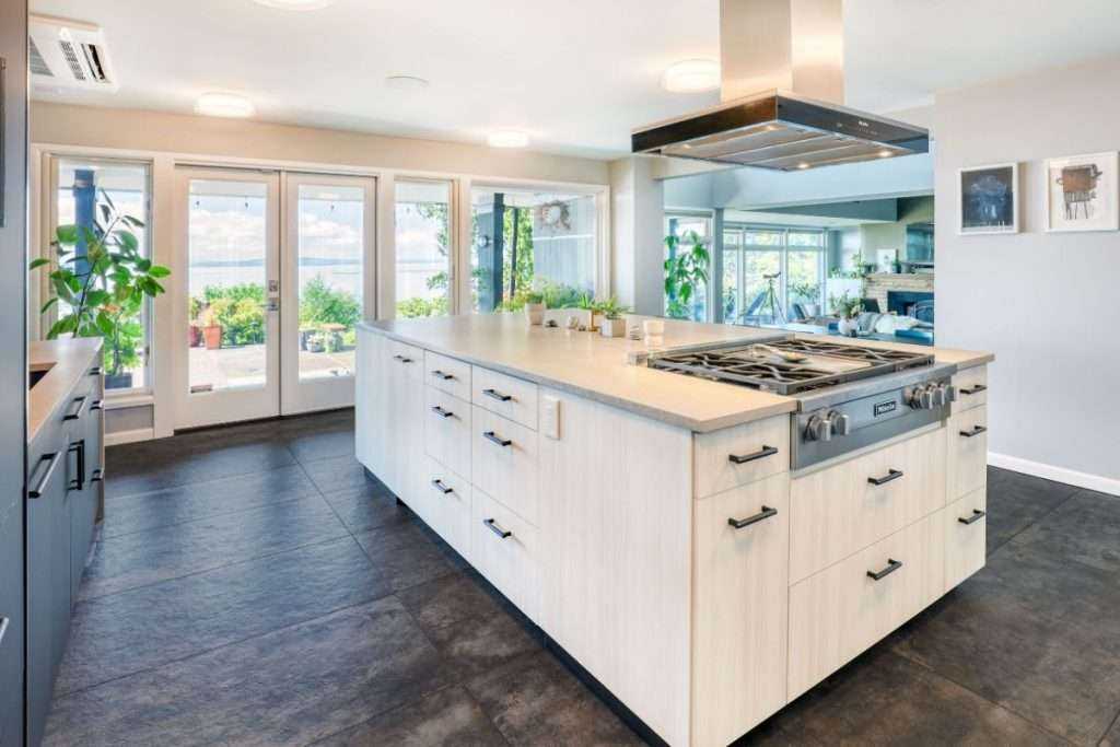 Modern kitchen with island and large windows overlooking lake