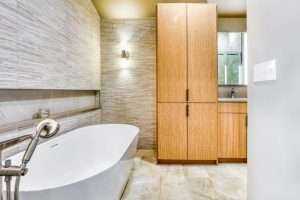 Modern bathroom with standalone tub and wooden cabinets