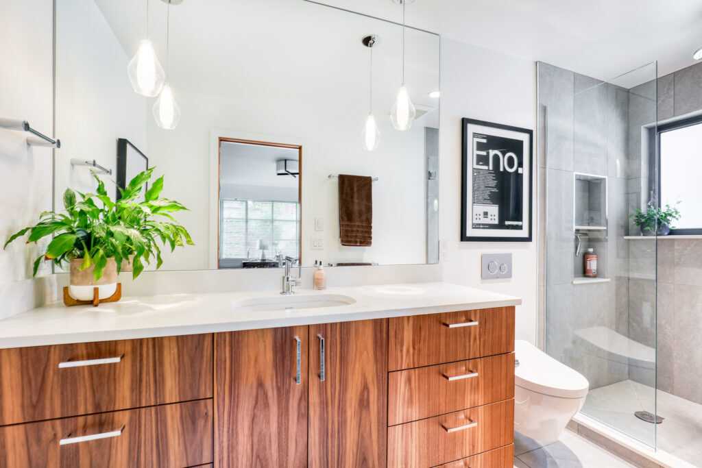 Modern bathroom with wooden cabinets and stylish lighting
