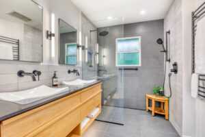 Modern bathroom with dual sinks and walk-in shower.