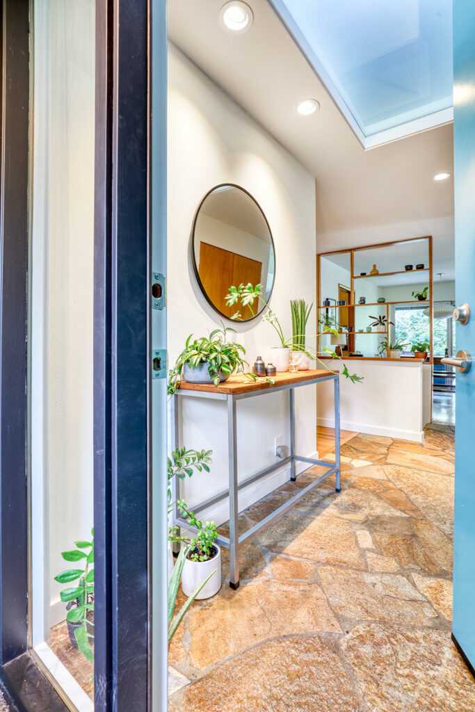 Bright modern bathroom with mirror and potted plants