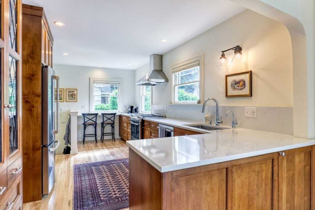 Bright modern kitchen with wooden cabinets and bar stools