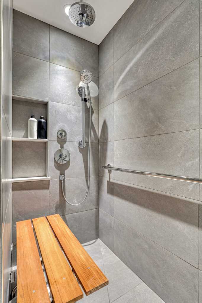 Modern bathroom with dual showerheads and wooden bench