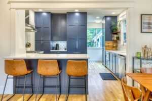 Modern kitchen with blue cabinets and island bar.