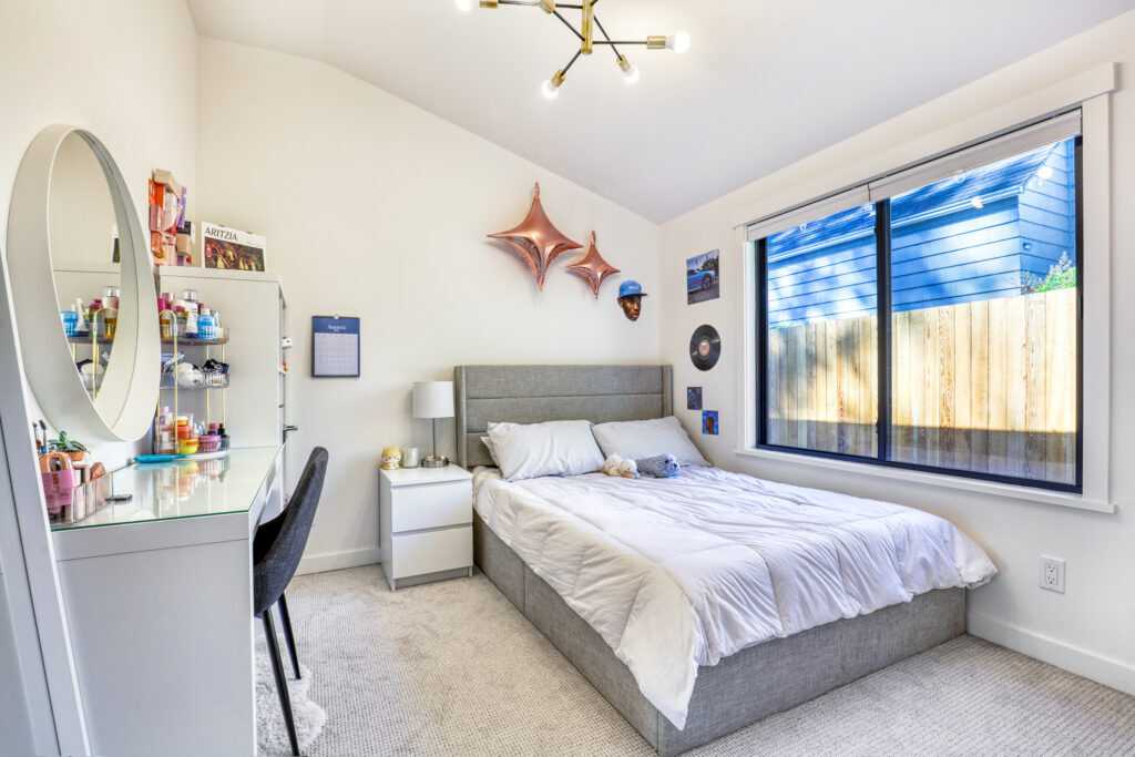 Modern bedroom with large window and stylish decor