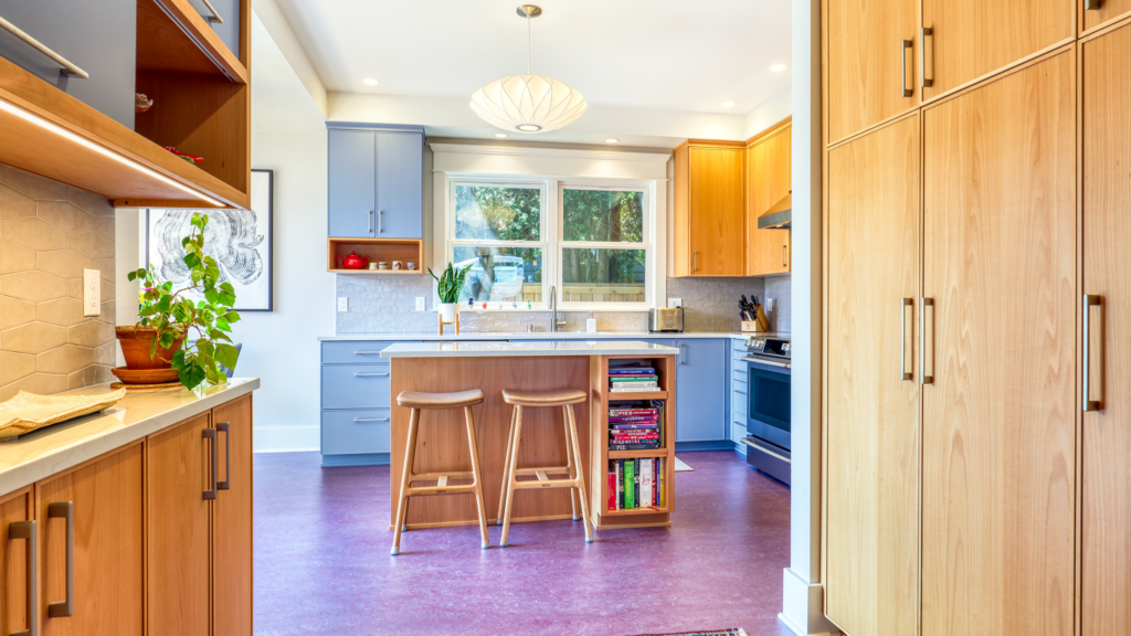 Wood and blue-gray cabinetry with a built-in bookshelf island, from a Seattle kitchen remodel.